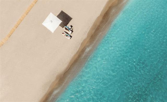 Ikos Resorts - Couple relaxing on the beach - 2880x1761.jpg