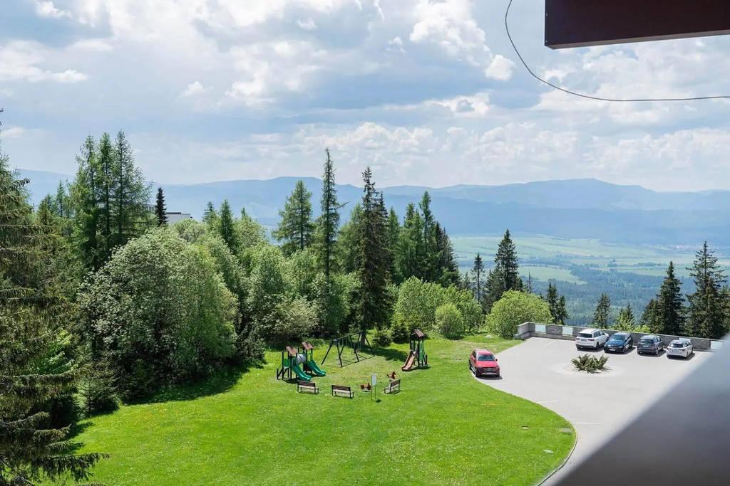 Výhled z hotelu na hory a dětské hřiště.