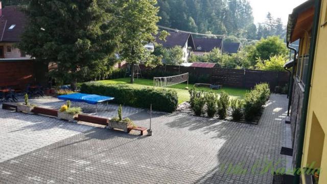 Äreál penzionu dvůr s terasou a hřiště.