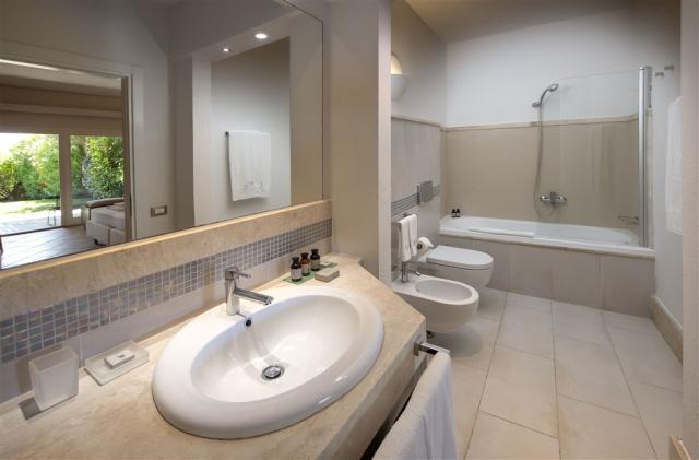 Chia Laguna_Hotel Village_Pool Room_Bathroom with bathtub.jpg